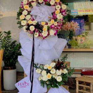 25102514 - Kệ hoa chia buồn mix lan tone tím